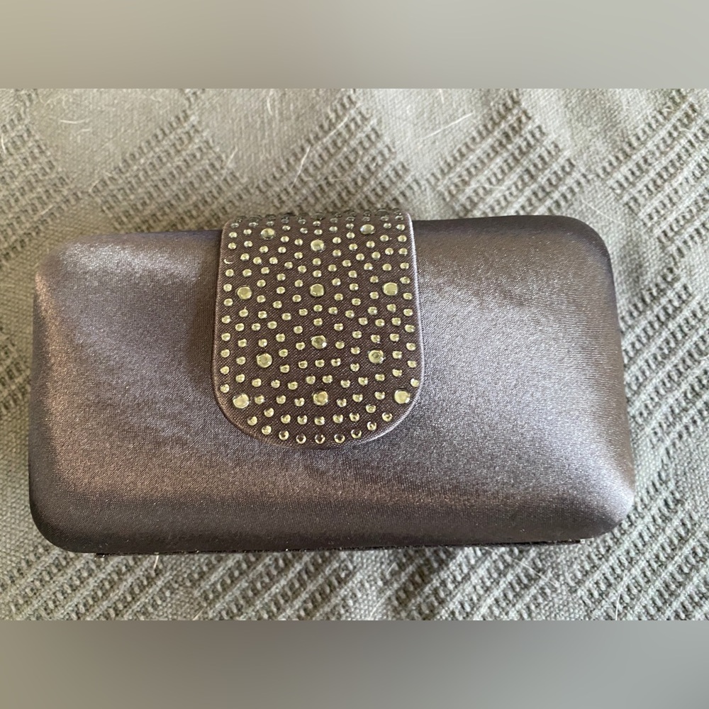 Gently used Hand held Grey Silk Clutch 3” x 6”. Elegent with beaded closure.